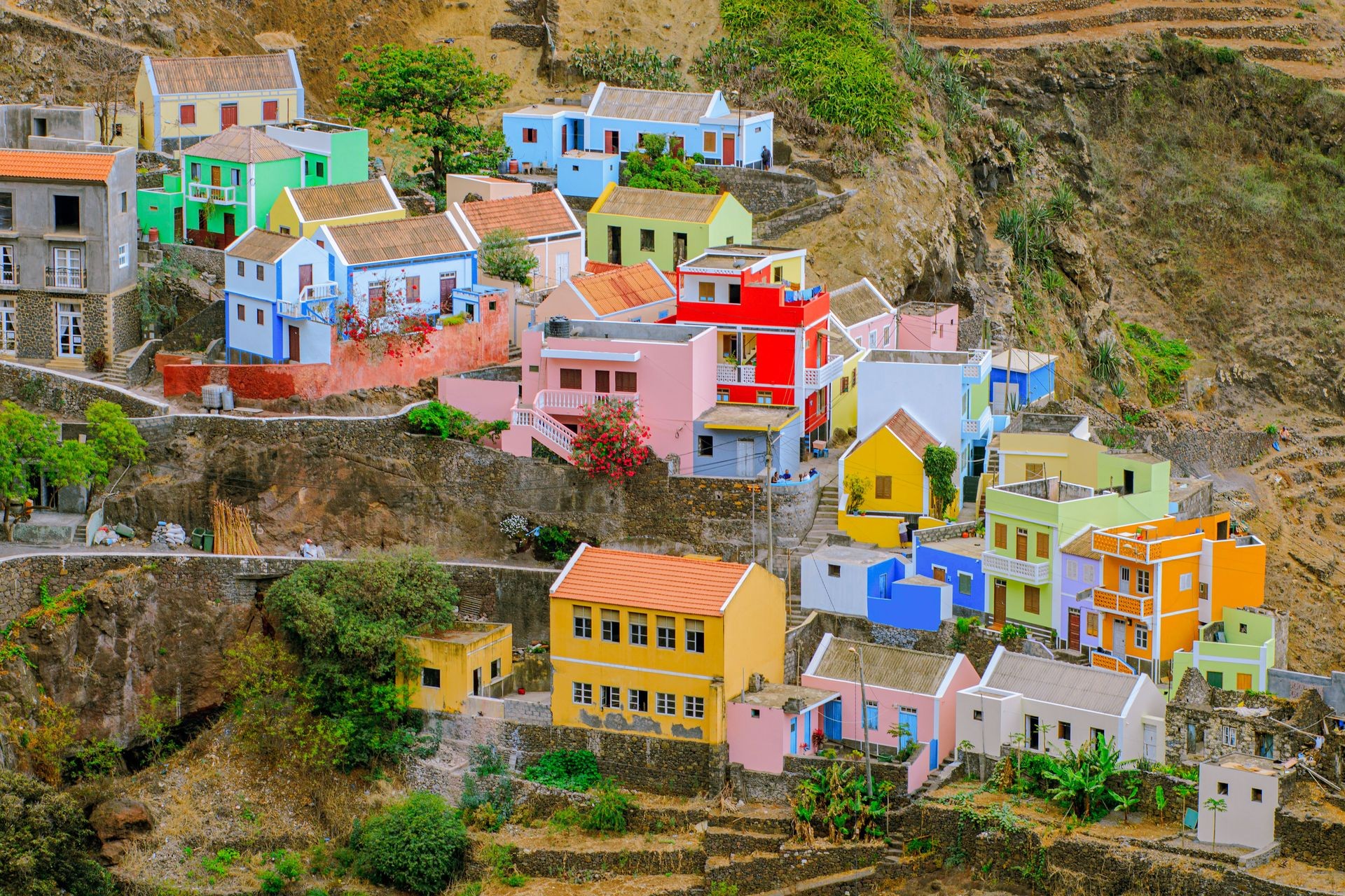 The stunning village of Fontainhas on Santo Antão, with its brightly colored houses perched precariously on a steep green mountain ridge.