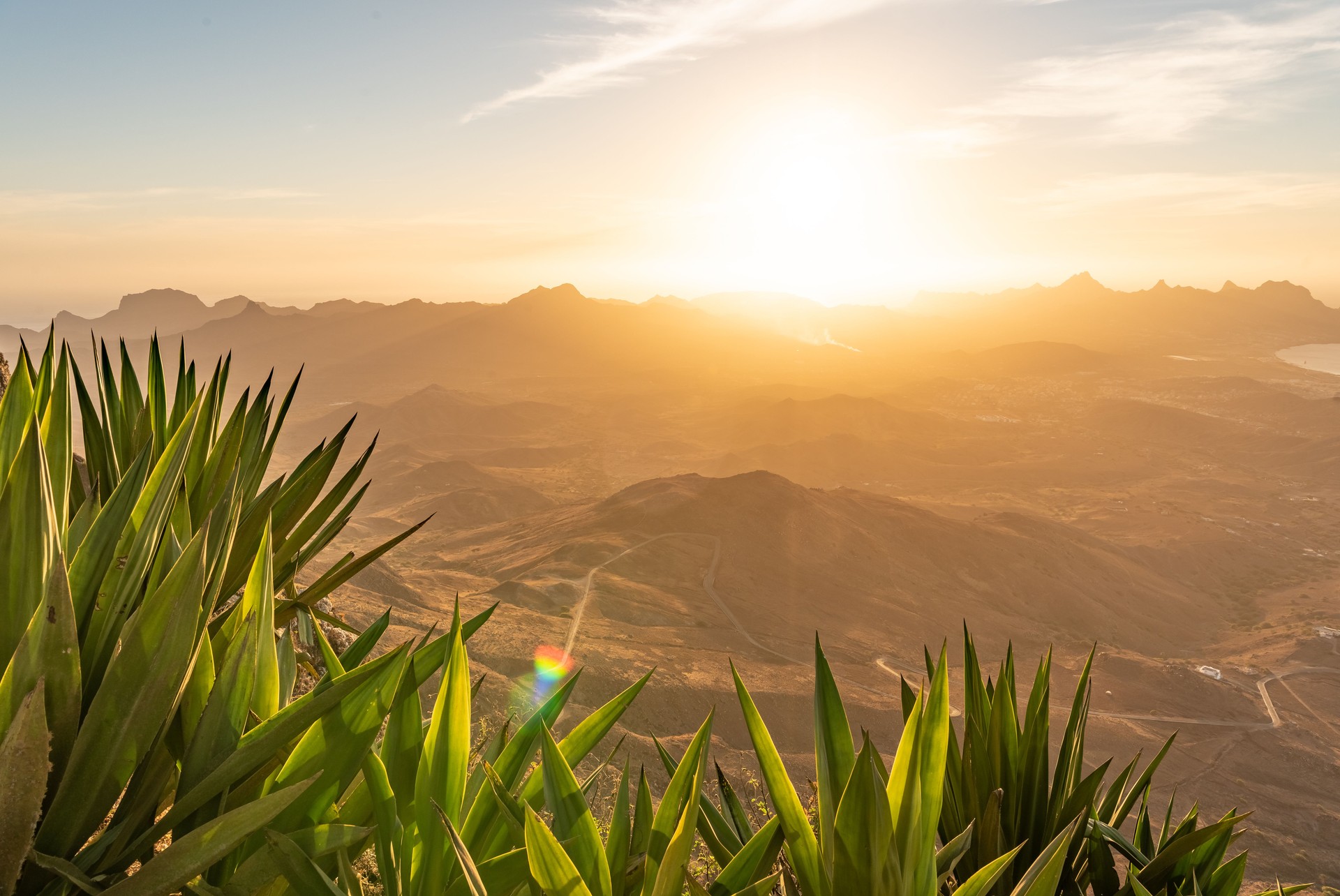 A stunning panoramic view from the peak of Monte Verde on São Vicente, looking down on the city of Mindelo and the surrounding ocean.