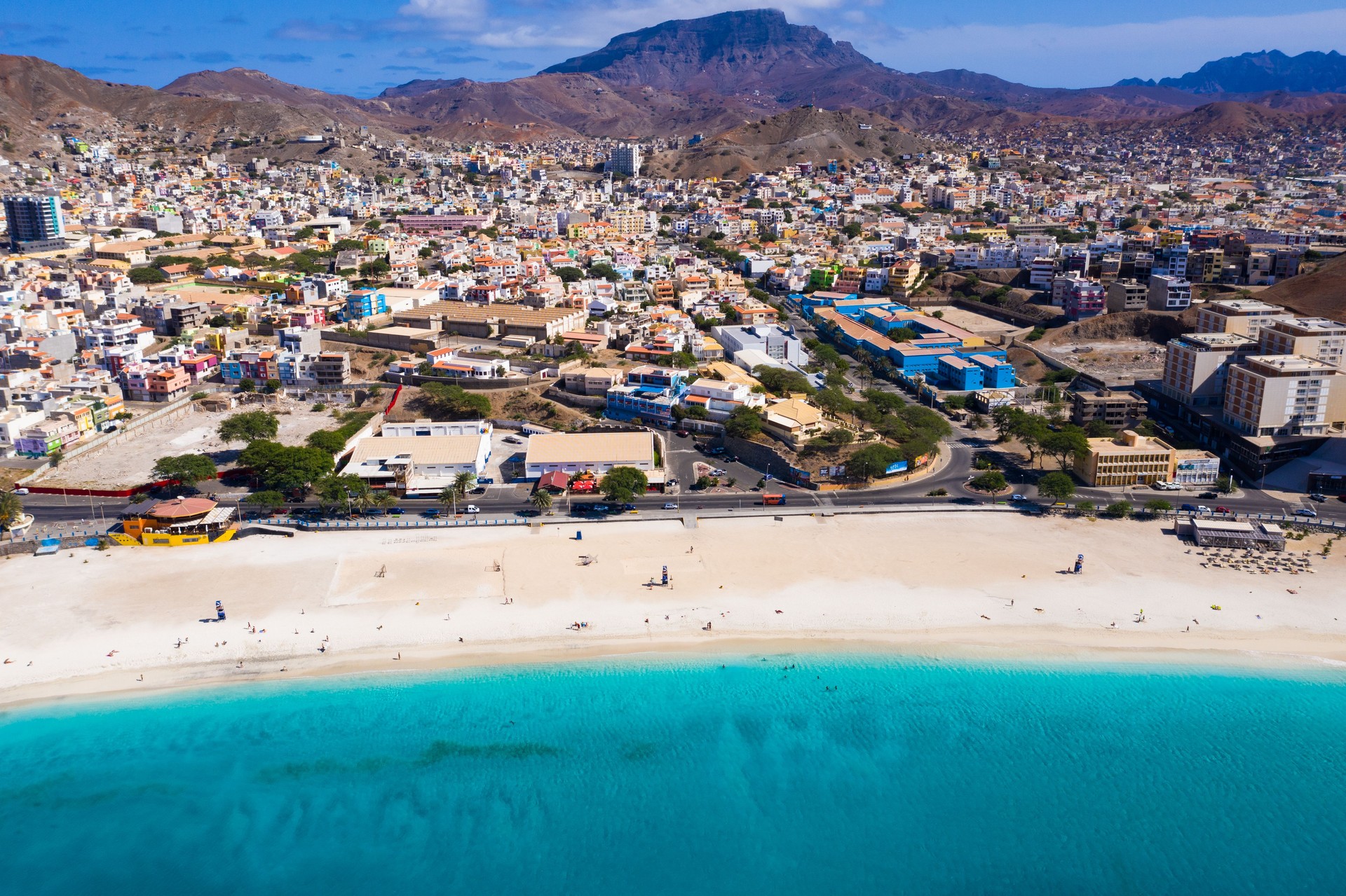 Aerial view of the beautiful Laginha Beach in Mindelo, São Vicente, with its white sand and clear turquoise water next to the city.