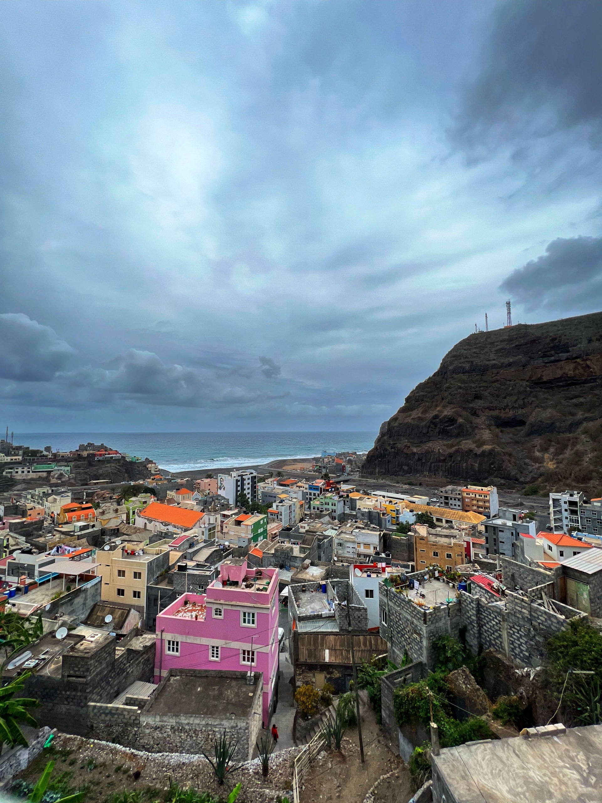 View of the town of Ribeira Grande on Santo Antão, nestled between steep, dramatic green and brown mountains.